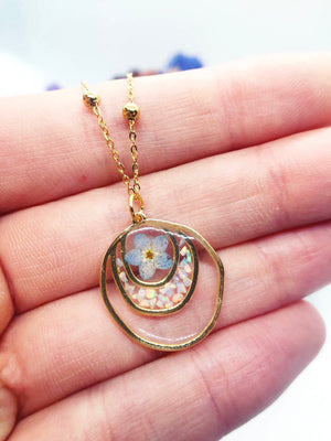 Forget me not real flower necklace and UV resin opal flakes. 18k gold plated Circles pendant.Resin jewelry.Forget-me-not pressed flowers